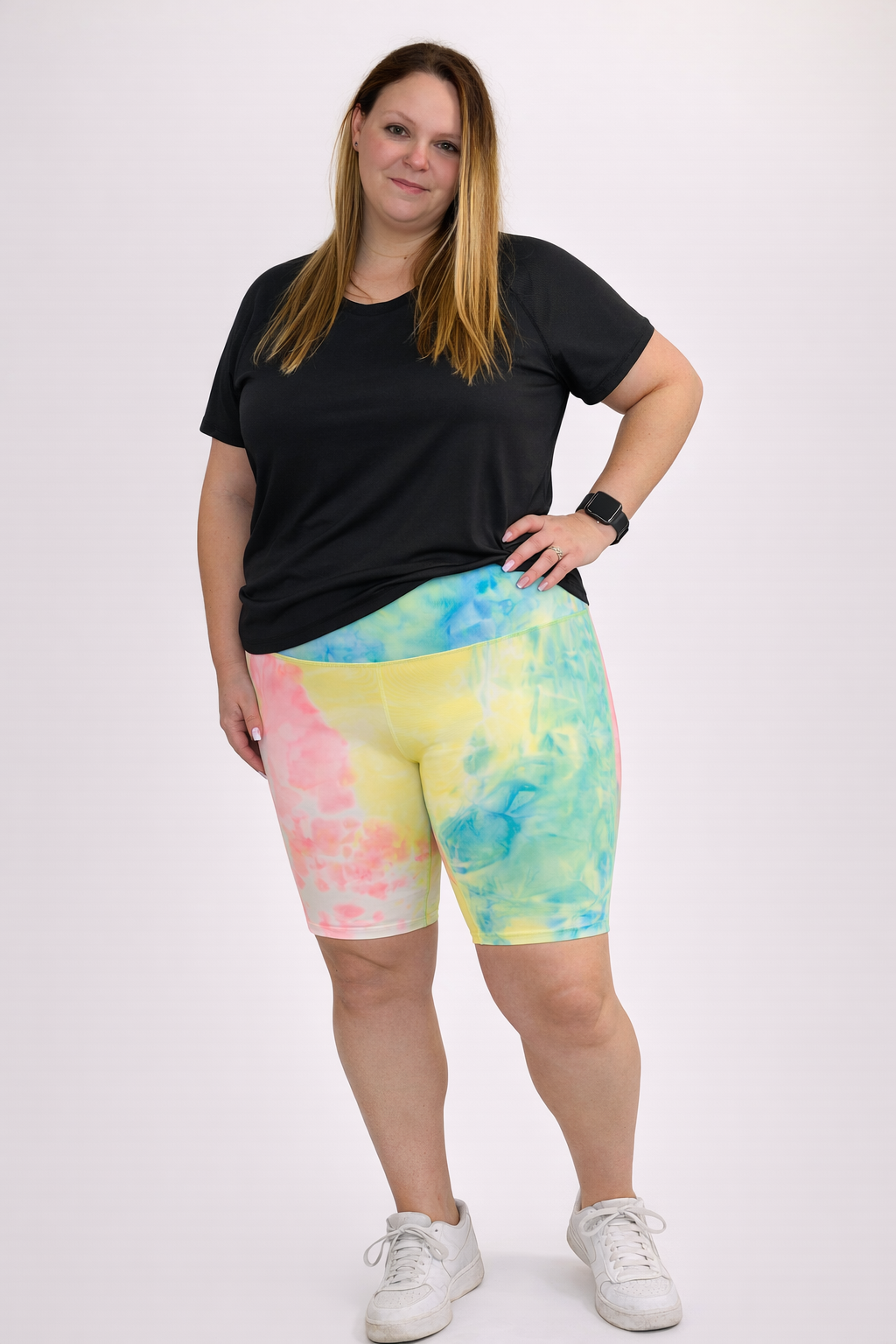Woman wearing pastel colored multicolor tye dye shorts