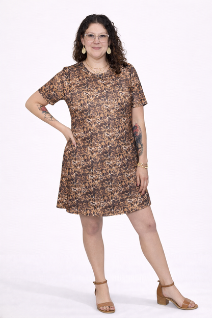 Woman wearing a leopard dress on a white background