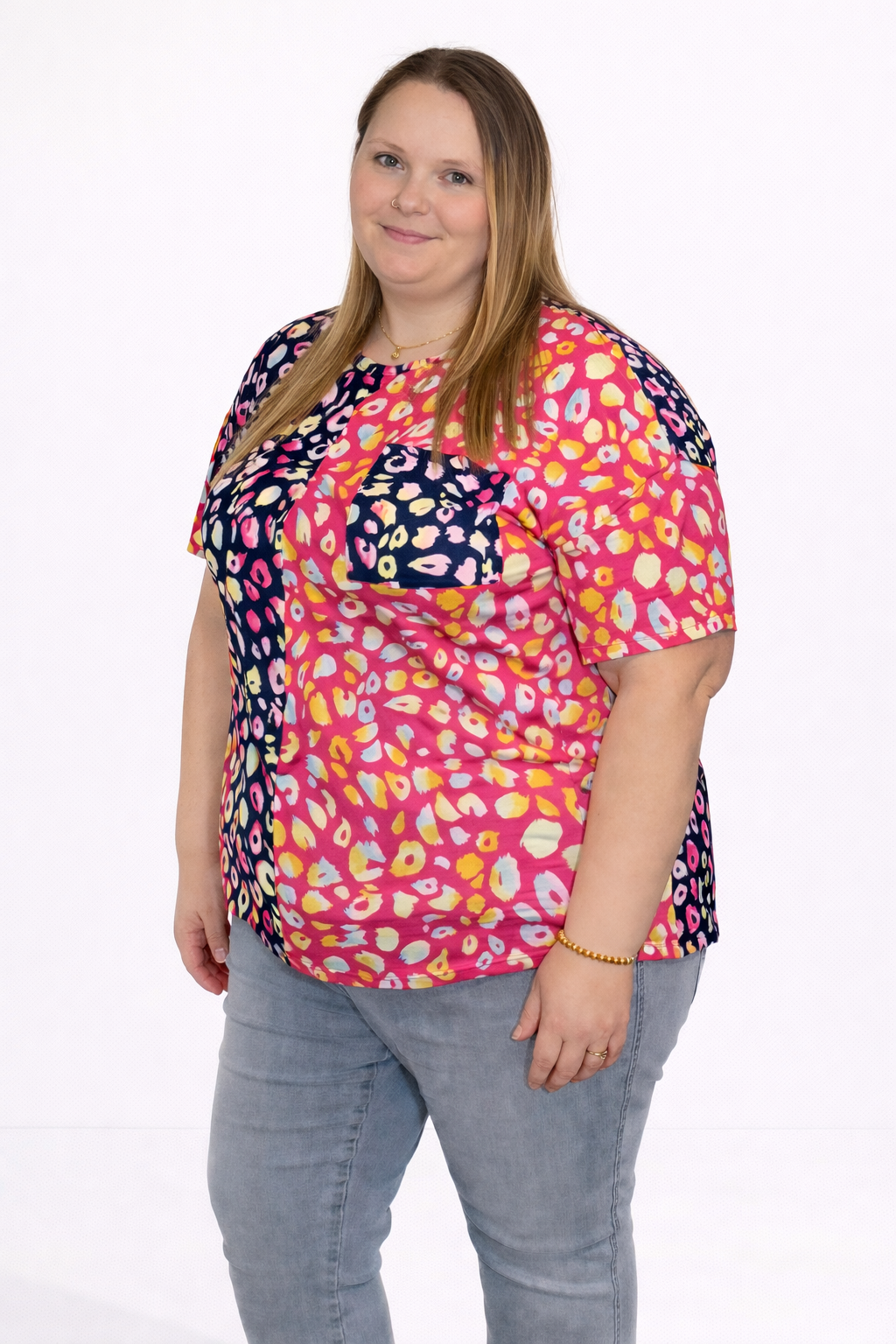 Woman wearing a colorful patterned top on a white background