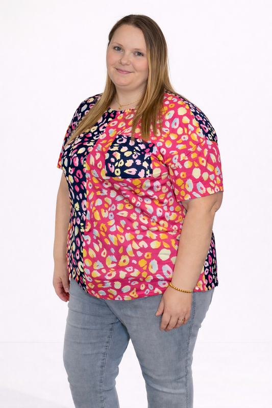 Woman wearing a colorful patterned top on a white background