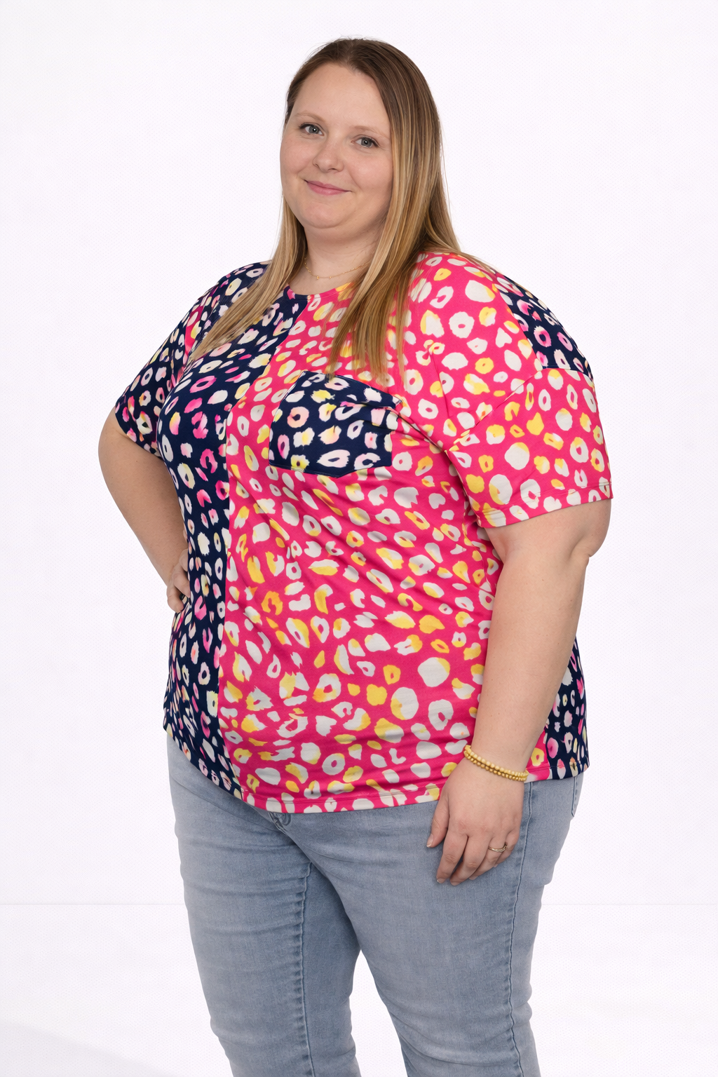 Woman wearing a colorful patterned top on a white background