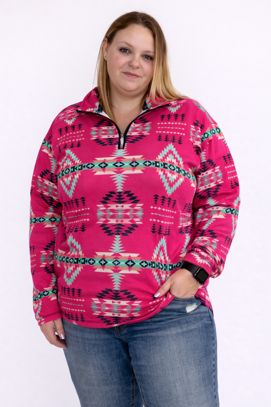 Person wearing a pink patterned pullover with blue jeans on a white background