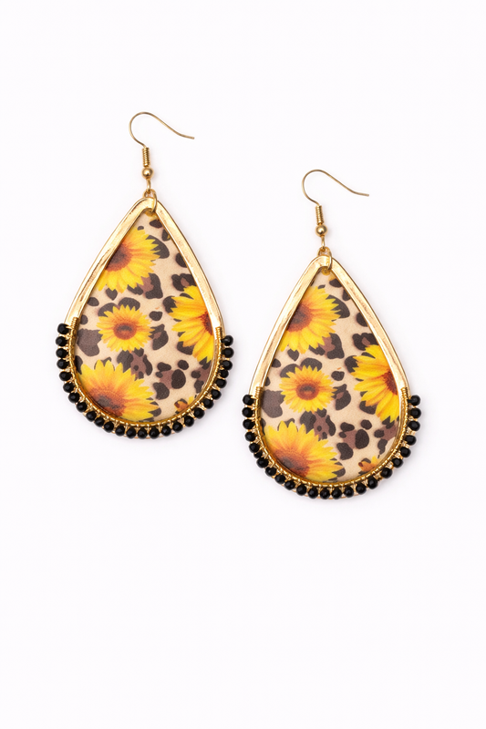 Teardrop-shaped earrings with floral and leopard print design on a white background
