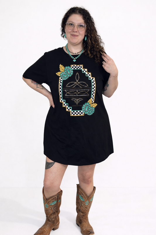Person wearing a black dress with a decorative emblem and brown boots on a white background