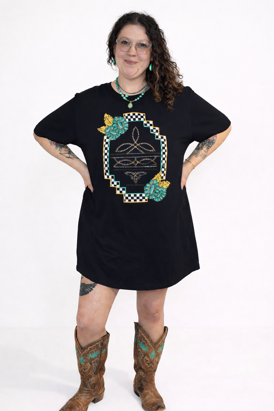 Person wearing a black dress with a decorative pattern and brown boots on a white background