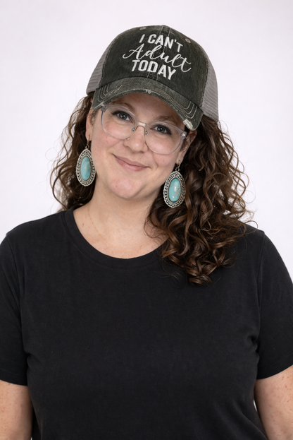 Person wearing a gray cap with 'I Can't Adult Today' text and a black shirt on a white background