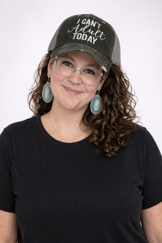 Person wearing a gray cap with 'I Can't Adult Today' text and a black shirt on a white background
