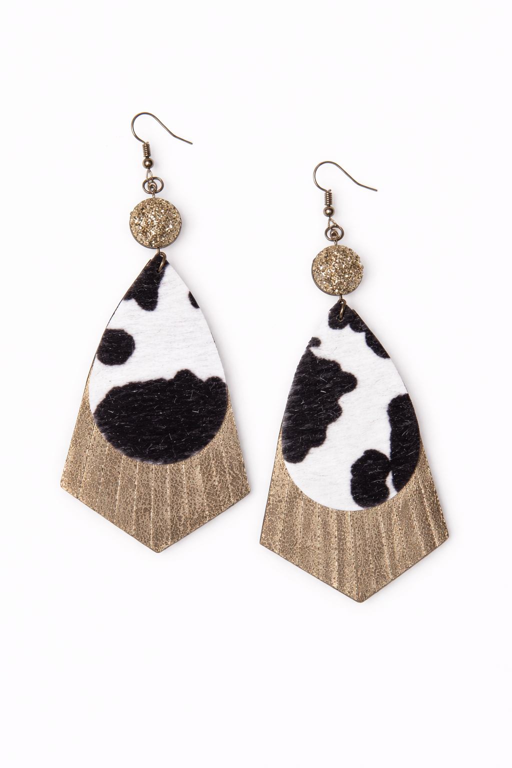 Cow print earrings with gold accents on a white background