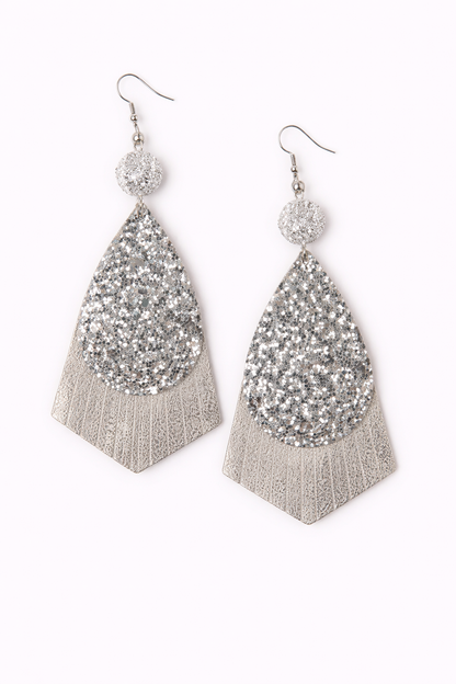 Pair of silver glittery teardrop earrings with fringe on a white background