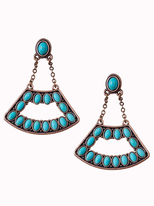 Turquoise earrings with bronze accents on a white background